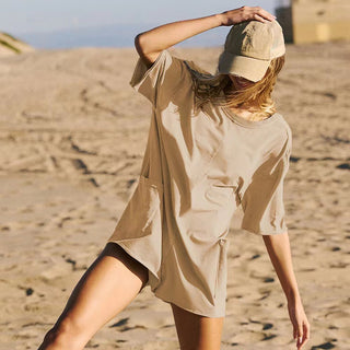 Beige short-sleeved summer jumpsuit with pockets, perfect for casual beach outings.