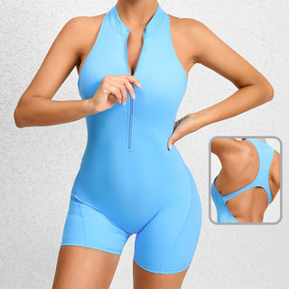Sleek blue activewear jumpsuit with zippered front and cutout back design, featuring a flattering silhouette and stretchy, tummy-control fabric for a confident athletic look.