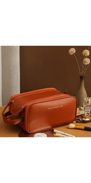 Stylish orange leather cosmetic bag with double zipper design, ideal for storing and organizing makeup, skincare products and personal care items on the go. Versatile accessory for the modern woman's beauty routine.