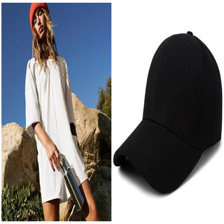 Casual Women's Backless Dress and Stylish Black Baseball Cap
This image showcases a woman wearing a white, loose-fitting, backless dress and standing in a scenic outdoor setting. The image also includes a separate black baseball cap, which could be a complementary accessory to the dress.