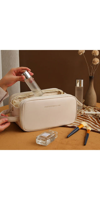 Stylish cream-colored cosmetic bag with dual zippers and sleek design, ideal for organizing and storing skin care products and makeup essentials.