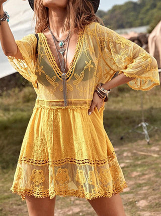 Elegant boho-chic yellow dress with intricate floral embroidery, billowing sleeves, and a plunging neckline, perfect for a summer getaway.