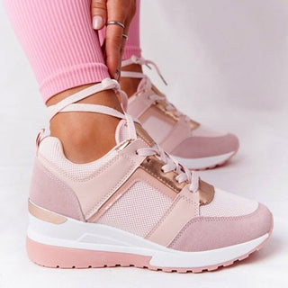 Stylish women's sneakers with chunky soles, a mix of pastel pink and white materials, and trendy lace-up design for a fashionable and comfortable athleisure look.