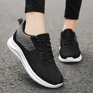 Sleek black lace-up sneakers with breathable mesh fabric on a light, comfortable sole for women