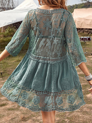 Elegant green lace dress with intricate embroidered floral patterns, ideal for outdoor events.