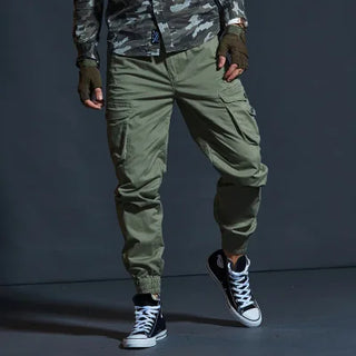 Rugged green tactical cargo pants with multiple pockets from K-AROLE, designed for versatile wear and functionality.