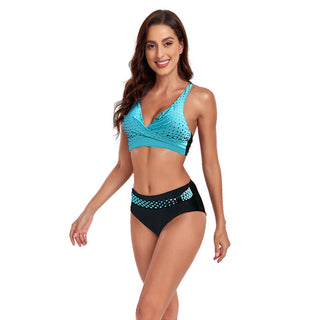 Stylish turquoise and black polka dot bikini swimsuit with halter top design and high-waisted bottoms.