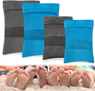 Plush beach towels in two contrasting colors - grey and teal blue, neatly folded and displayed. The towels appear soft and comfortable, suitable for outdoor activities like camping or relaxation at the beach. The image also shows people's bare feet in the foreground, suggesting the towels could be used for drying off or providing a cozy surface to lounge on.