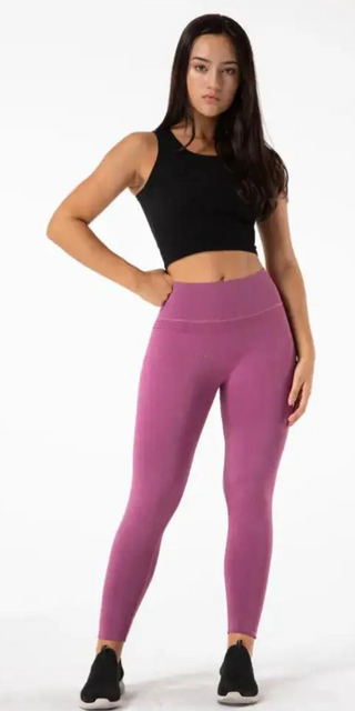 High-quality sporty leggings with a sleek, vibrant pink design. Flexible, breathable fabric ideal for yoga, pilates, or other fitness activities. Complemented by a stylish black cropped top, creating a trendy athleisure look.