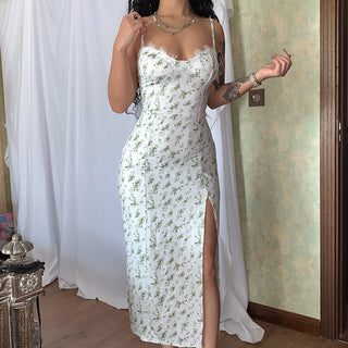 Elegant white floral print dress with slit and suspender detail, worn by female model in front of white curtain background