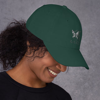 Green baseball cap with butterfly logo from K-AROLE, a women's fashion sneaker brand, on model with curly hair against a gray background.