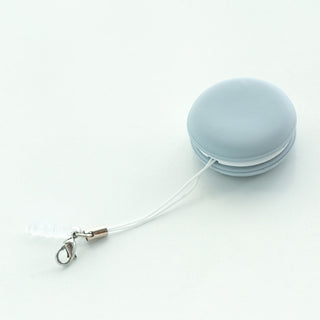 Trendy macaron-shaped keychain screen cleaner with soft, light blue color on white background.