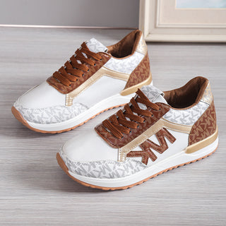 Stylish women's sneakers with a contrasting pattern, rounded toe, and thick rubber soles, suitable for active lifestyles.