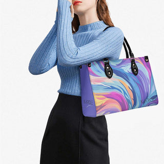 Stylish swirling pattern handbag held by woman in cozy knit sweater