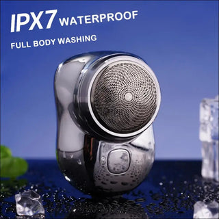 Waterproof electric shaver with IPX7 full body washing capability, featuring a sleek chrome design and placed on a wet surface with splashing water.