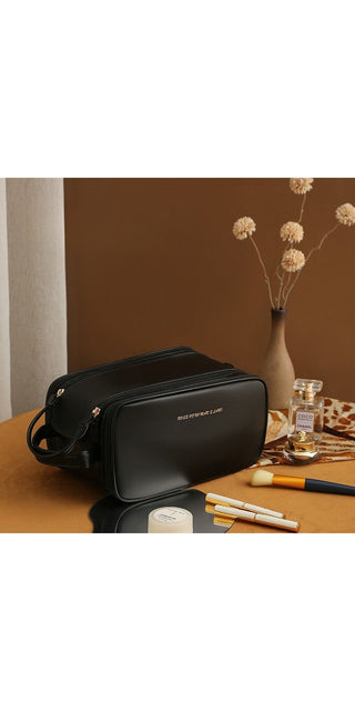 Stylish black leather makeup bag with U-shaped double zipper design. Spacious interior provides convenient storage for various cosmetic products. Ideal for women's daily skincare and beauty routine. Elevated design adds a touch of sophistication to your vanity.