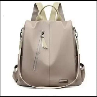 Stylish beige backpack with multiple compartments and zippers, perfect for school or everyday use.