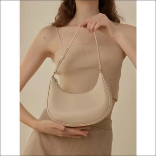 Versatile beige shoulder bag from K-AROLE featuring a chic half-moon design, perfect for completing women's athleisure outfits.