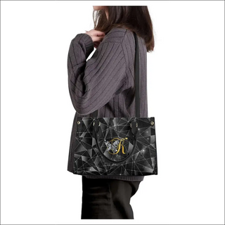 Geometric Black Handbag: Stylish K-AROLE tote with intricate pattern and gold-tone hardware, complementing the trendy women's athleisure outfits.