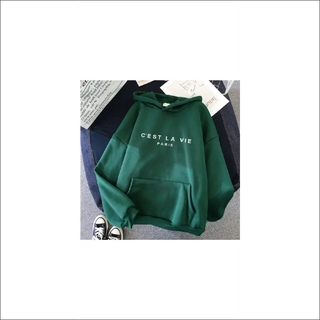 Casual green hoodie with 'C'est la vie Paris' text printed on the front, displayed on a white background along with a pair of black sneakers.