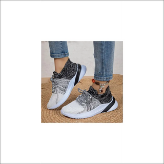 Trendy knit sneakers with a breathable mesh design for active women. Featuring a lace-up closure and a durable sole, these comfortable sports shoes are perfect for running, walking, or casual wear.