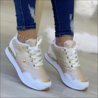 Fashionable plaid sneakers with lace-up design and love embellishments, showcased on a person's feet wearing distressed denim jeans.