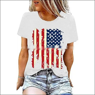 Stylish American flag graphic printed white t-shirt on a female model with casual denim shorts and blonde hair