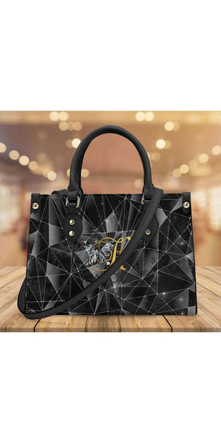 Elegant black geometric handbag from K-AROLE with chic studded accents, perfect for fashionable athleisure outfits.