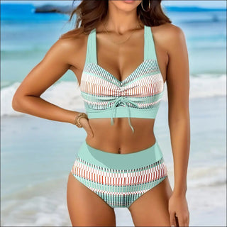 Stylish striped swimsuit top and bottoms on tropical beach