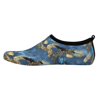 Stylish men's water sports skin shoes with a tropical leaf and leopard print pattern against a blue background. The slip-on design features a flexible, protective material suitable for aquatic activities.