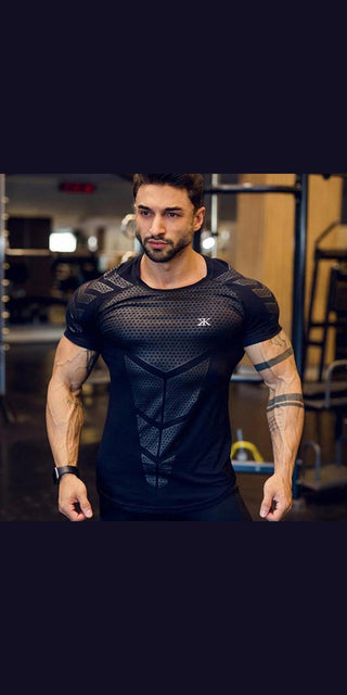 Athletic man wearing black compression t-shirt with mesh panels, showcasing muscular physique in gym setting.